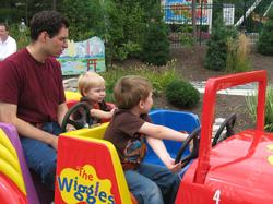 Boys driving the Big Red Car.